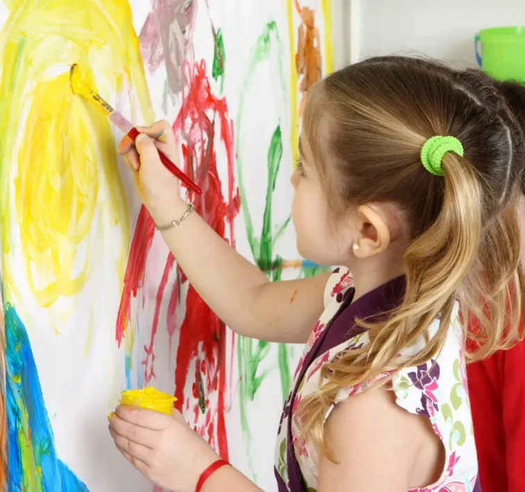 A student painting at an easel during a learning program