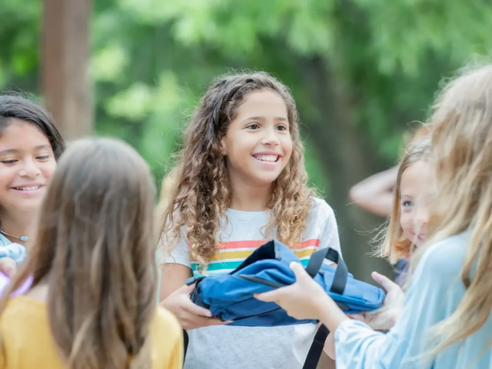Middle school students talking and smiling outdoors