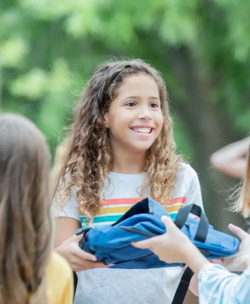 Middle school students talking and smiling outdoors