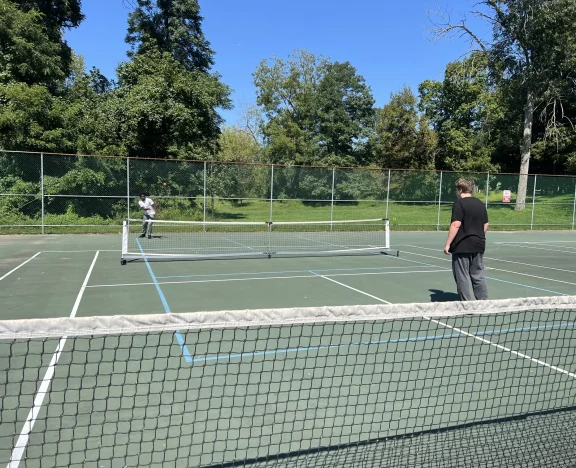 Students playing tennis together